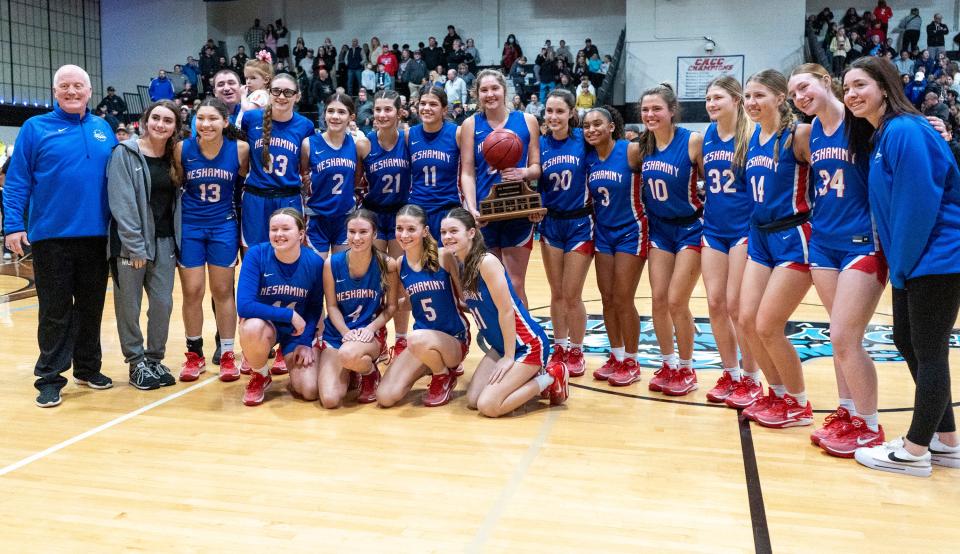 The Neshaminy girls celebrate their win over Upper Dublin to claim the Suburban One League Tournament title at Holy Family on Feb. 13.