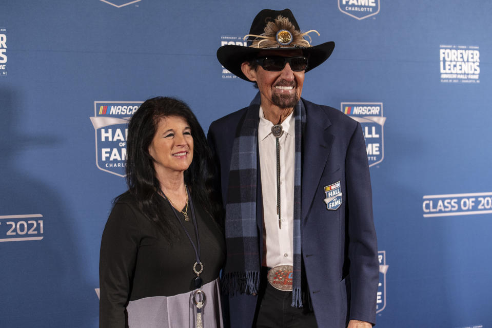 NASCAR Hall of Fame member Richard Petty, right, stops to pose for photos before the induction ceremony on Friday, Jan. 21, 2022, in Charlotte, N.C. (AP Photo/Matt Kelley)