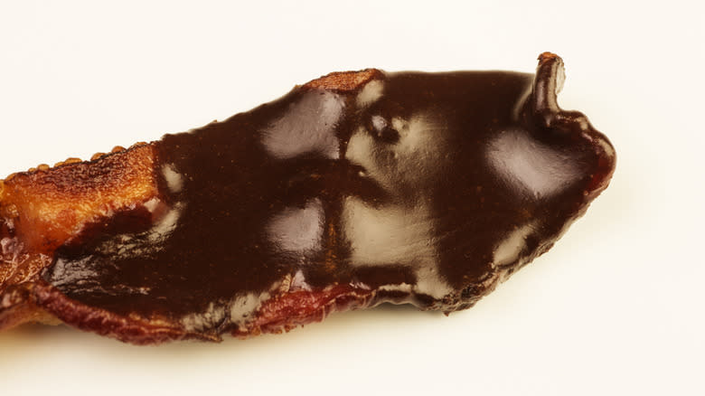 Close up image of chocolate on bacon strip