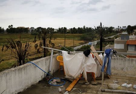 A makeshift shower cabin and toilet are seen atop a deserted hotel, where hundreds of migrants found temporary shelter on the Greek island of Kos, Greece, May 27, 2015. REUTERS/Yannis Behrakis