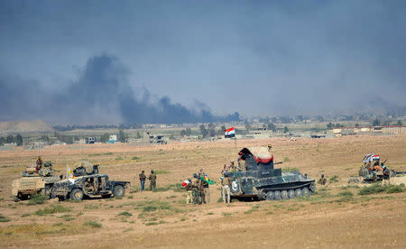 Shi'ite Popular Mobilization Forces (PMF) gather with Iraqi army on the outskirts of Tal Afar, Iraq, August 22, 2017. REUTERS/Stringer