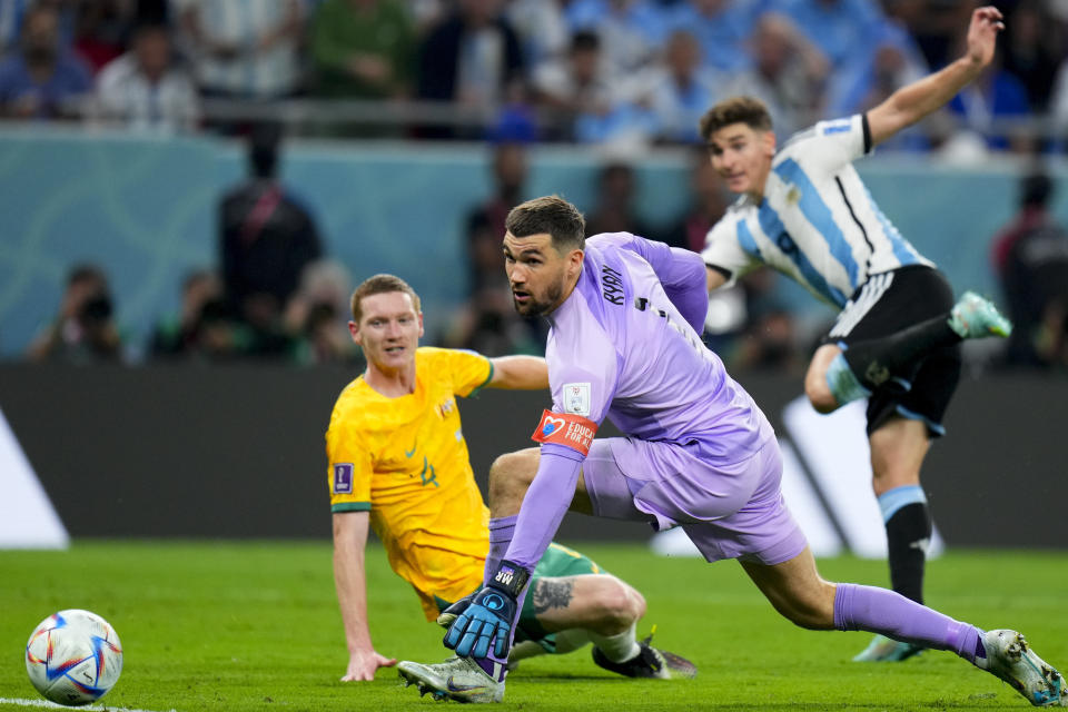 Australia's goalkeeper Mathew Ryan, center, fails to stop Argentina's Julian Alvarez from scoring his side's second goal during the World Cup round of 16 soccer match between Argentina and Australia at the Ahmad Bin Ali Stadium in Doha, Qatar, Saturday, Dec. 3, 2022. (AP Photo/Petr David Josek)