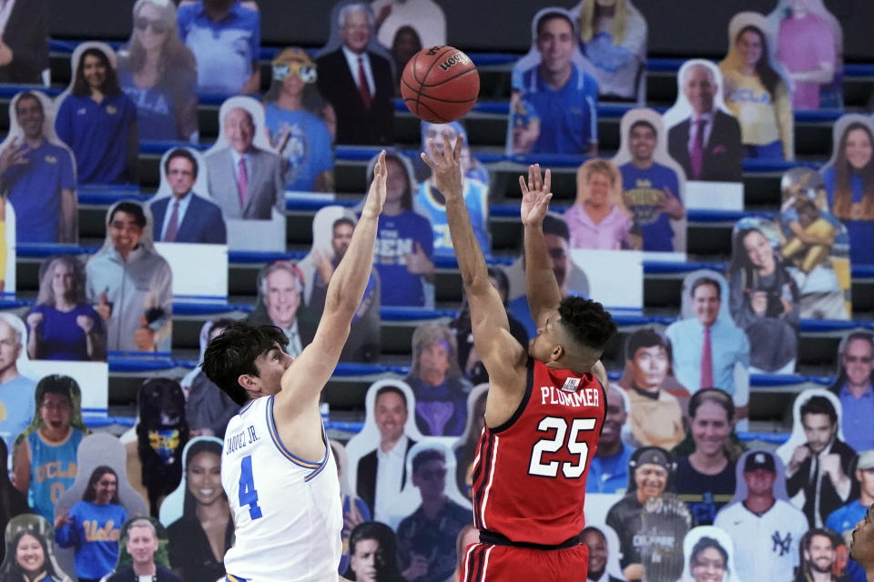 Utah guard Alfonso Plummer (25) shoots over UCLA guard Jaime Jaquez Jr. (4) during the second half of an NCAA college basketball game Thursday, Dec. 31, 2020, in Los Angeles. (AP Photo/Marcio Jose Sanchez)