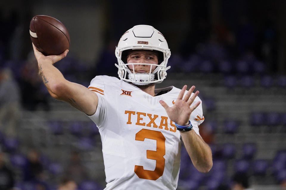 Texas quarterback Quinn Ewers warms up before an NCAA college football game against TCU, Saturday, Nov. 11, 2023, in Fort Worth, Texas. (AP Photo/Julio Cortez)