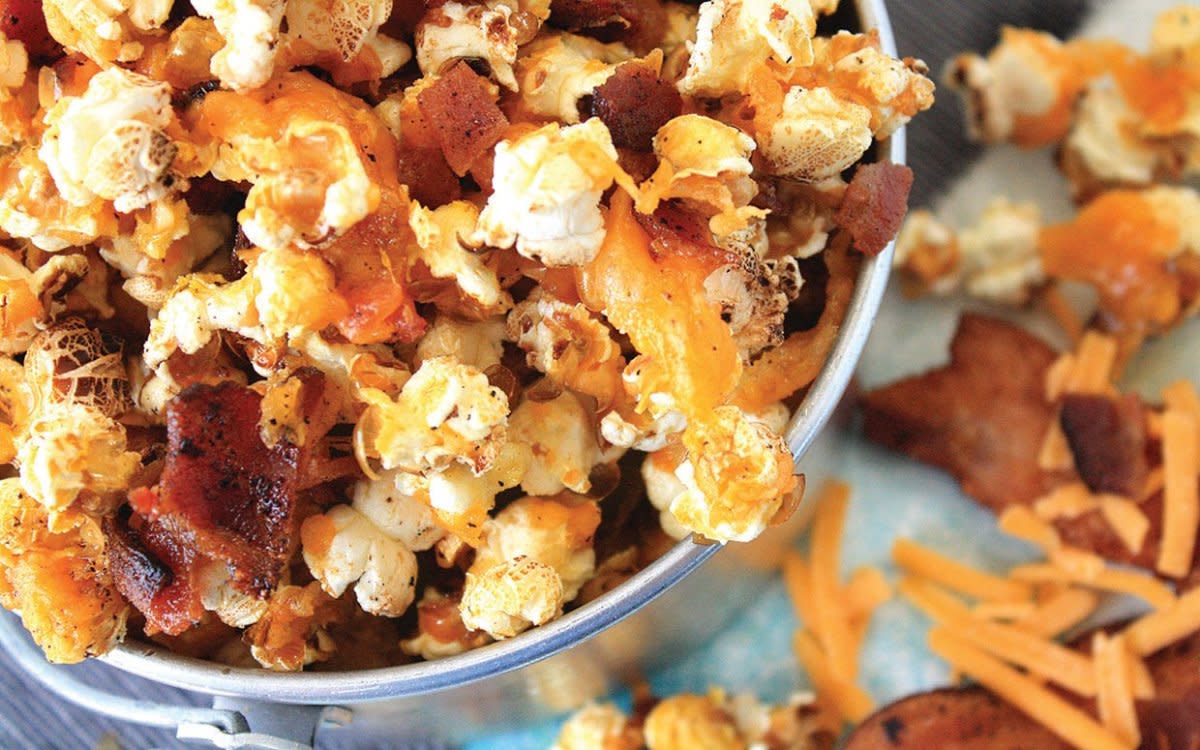 <p>Georgeann Bell</p><p>Popcorn is such a classic snack. Take it over the top with the addition of cheese and bacon!</p><p><strong>Get the recipe: <a href="https://parade.com/646941/parade/easiest-ever-cheddar-bacon-popcorn/" rel="nofollow noopener" target="_blank" data-ylk="slk:Cheddar Bacon Popcorn;elm:context_link;itc:0;sec:content-canvas" class="link rapid-noclick-resp">Cheddar Bacon Popcorn</a></strong></p>