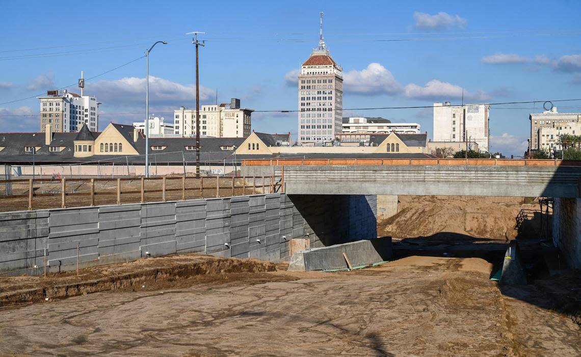 California High Speed Rail construction continues on the Tulare Street underpass in Fresno’s Chinatown on Thursday, Dec. 8, 2022. Muralist Mauro Carrera is working on a project nearby with the Fresno Arts Council and the California High Speed Rail Authority.