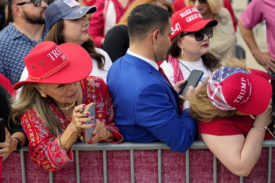 Supporters wait to greet Republican presidential candidate and former President Donald Trump at the South Texas International Airport Sunday, Nov. 19, 2023, in Edinburg, Texas. (AP Photo/Eric Gay)