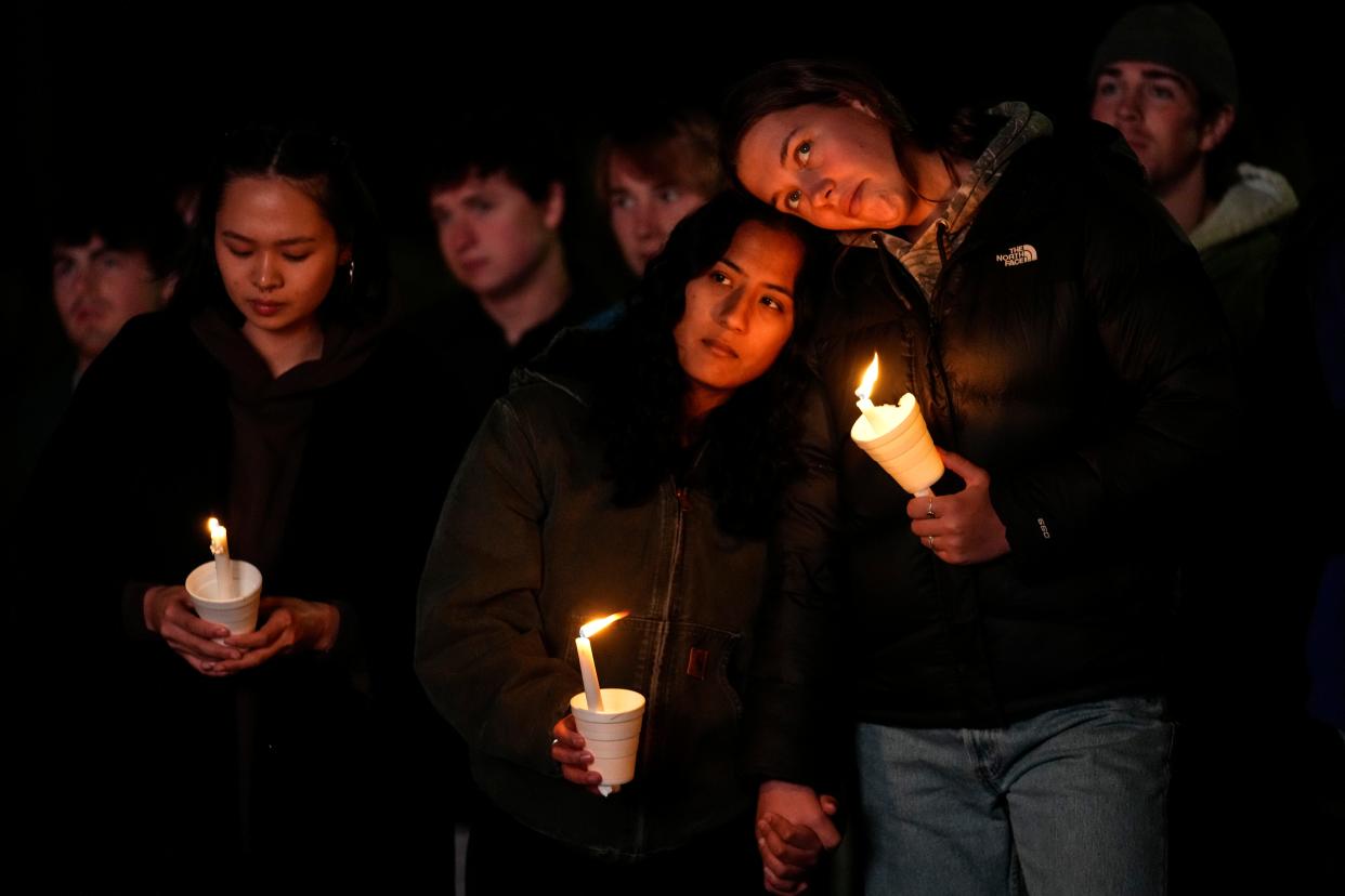 People gather at a vigil for the victims of Wednesday's mass shootings, Sunday, Oct. 29, 2023, outside the Basilica of Saints Peter and Paul in Lewiston, Maine.