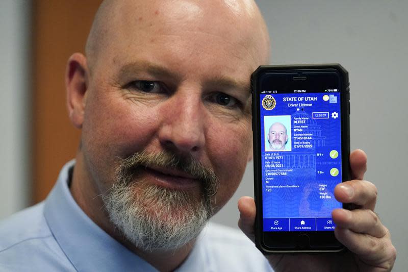Ryan Williams, with the Utah Drivers License Division, displayes his cell phone with the pilot version of the state’s mobile ID on Wednesday, May 5, 2021, in West Valley City, Utah. (AP Photo/Rick Bowmer)