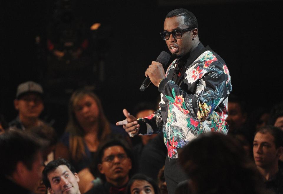 Sean "Diddy" Combs presents the award for song of the year at the iHeartRadio Music Awards at the Shrine Auditorium on Thursday, May 1, 2014, in Los Angeles. (Photo by Chris Pizzello/Invision/AP)