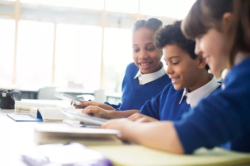 Children smiling in a classroom