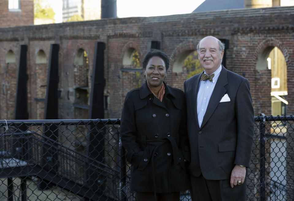 Christy Coleman, left, director of the American Civil War Center at Tredegar Iron Works, left, and Waite Rawls of the Museum of the Confederacy, pose in front of the ruins of the old Tredegar Iron Works in Richmond, Va., Wednesday, Nov. 13, 2013. (AP Photo/Steve Helber)