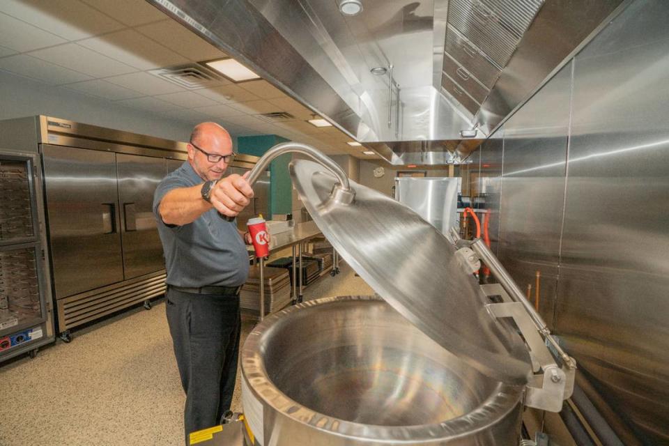 School district 201 superintendent Brian Mentzer opens an industrial cooker in the Center for Academic and Vocational Excellence on Aug. 9, 2023. The cave recently went through a series of upgrades and plans to renovate even further.
