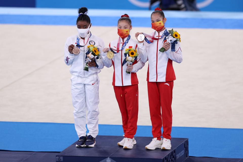 Silver medalist Xijing Tang of Team China, gold medalist Chenchen Guan of Team China and bronze medalist Simone Biles of Team United States (Getty)