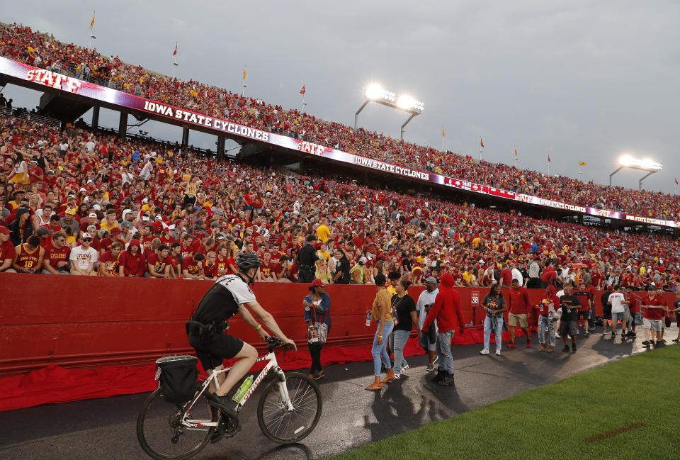 Fans are asked to leave the stadium after lightning was spotted as Iowas State takes on South Dakota State in an NCAA college football game, Saturday, Sept. 1, 2018, in Ames, Iowa. (AP Photo/Matthew Putney)