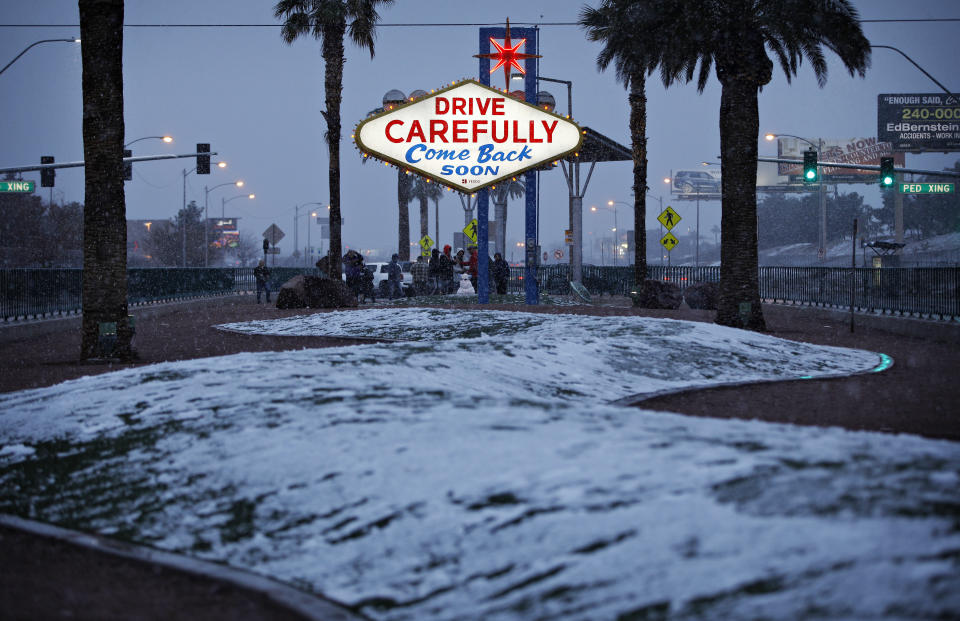 Snow accumulates on a median along the Las Vegas Strip at the "Welcome to Fabulous Las Vegas" sign, Thursday, Feb. 21, 2019, in Las Vegas. Las Vegas is getting a rare taste of real winter weather, with significant snowfall across the metro area in the first event of its kind since record keeping started back in 1937. (AP Photo/John Locher)