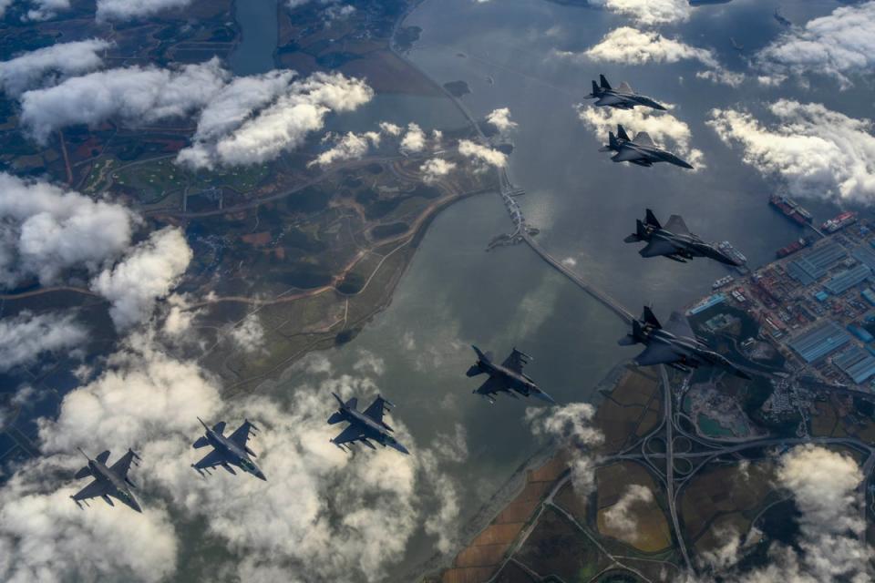 In this handout image released by the South Korean Defense Ministry, South Korean Air Force F-15Ks and US Air Force F-16 fighter jets fly over the Korean Peninsula in response to North Korea’s intermediate-range ballistic missile (IRBM) launch at an undisclosed location (Getty Images)