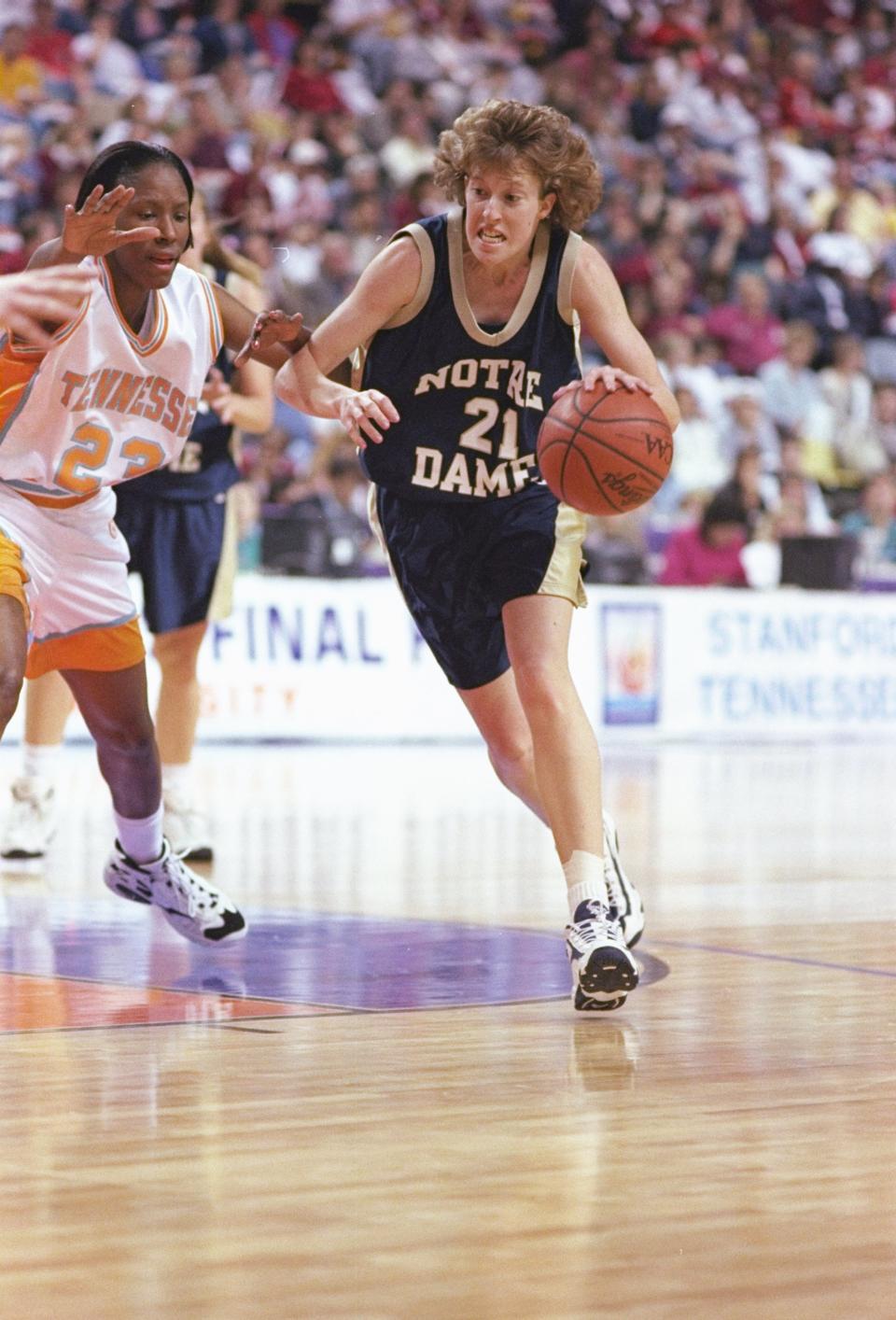 28 Mar 1997: Beth Morgan of the Notre Dame Fighting Irish drives to the basket as Chamique Holdsclaw of the Tennessee Volunteers guards her during a playoff game at Riverfront Coliseum in Cincinnati, Ohio. Tennessee won the game 80 – 66. Jonathan Daniel-Getty Images