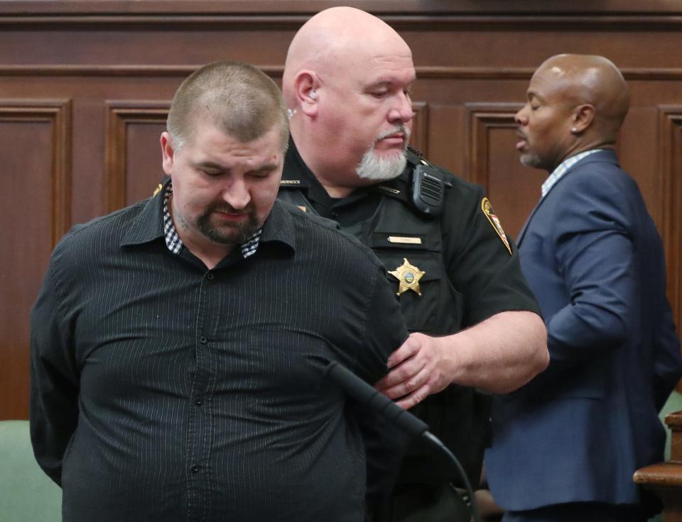 William Huston is led away by a Summit County sheriff's deputy after being sentenced in Summit County Common Pleas Court for involuntary manslaughter in the death of his 6-year-old son, Logan. Defense attorney Job Perry is in the background.