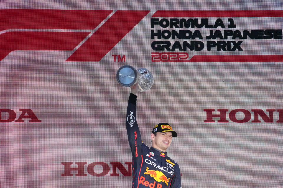 Red Bull driver Max Verstappen of the Netherlands holds aloft trophy during the Japanese Formula 1 Grand Prix at the Suzuka Circuit in Suzuka, central Japan, Sunday, Oct. 9, 2022. Verstappen secured second consecutive Formula One drivers' championship. (AP Photo/Toru Hanai)