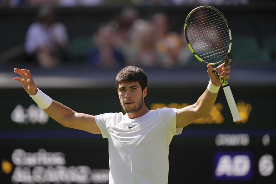 Spain's Carlos Alcaraz celebrates after beating Alexandre Muller of France in a men's singles match on day five of the Wimbledon tennis championships in London, Friday, July 7, 2023. (AP Photo/Alberto Pezzali)