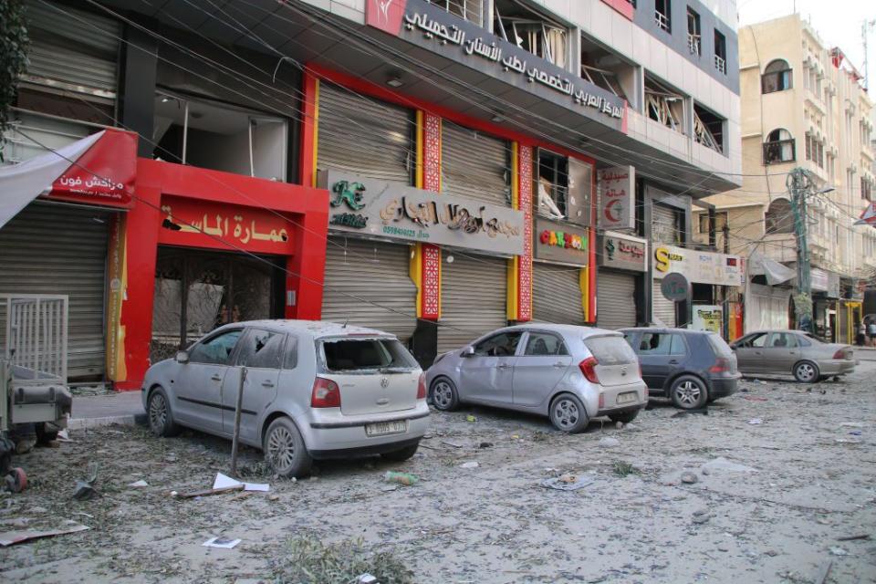 Palestinian citizens inspect damage to their homes and business after Sunday's airstrikes by Israel in the Gaza Strip.