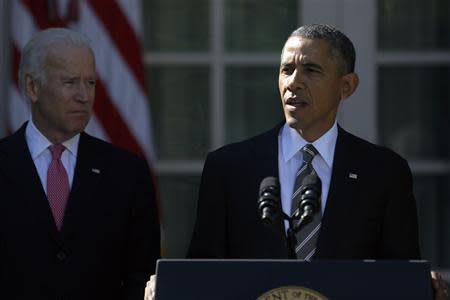 U.S. Vice President Joe Biden (L) stands with President Barack Obama as he announces Jeh Johnson to be his nominee for Secretary of Homeland Security, in the Rose Garden of the White House in Washington, October 18, 2013. REUTERS/Jonathan Ernst