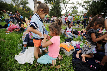 Children help each other get dressed in Ocotepeque, Honduras October 14, 2018. REUTERS/ Jorge Cabrera