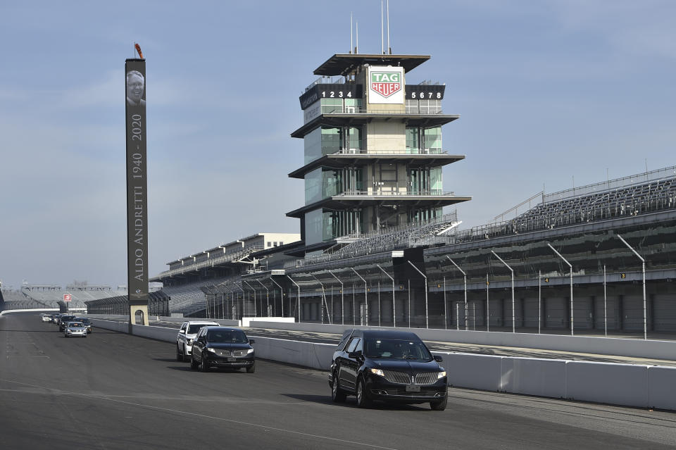 This photo provided by Indianapolis Motor Speedway shows the funeral procession for Aldo Andretti, twin brother of Mario Andretti, taking a lap around the track before funeral services Wednesday, Jan. 13, 2021. Mario feels the same pain as so many others these days. His wife died two years ago, long before the pandemic. And his beloved nephew lost a brutal battle with colon cancer. But then COVID-19 claimed his twin brother Aldo and one of the greatest racers of all time is not immune from the loneliness and depression sweeping the world. (Chris Owens/Courtesy IMS Photo via AP)