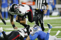 Atlanta Falcons quarterback Desmond Ridder (4) leaps over Detroit Lions cornerback Saivion Smith during the second half of a preseason NFL football game, Friday, Aug. 12, 2022, in Detroit. (AP Photo/Duane Burleson)