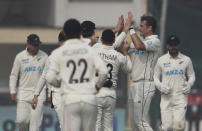 New Zealand's players Tim Southee, second right, celebrates the dismissal of India's Shreyas Iyer with his teammates during the day two of their first test cricket match in Kanpur, India, Friday, Nov. 26, 2021. (AP Photo/Altaf Qadri)