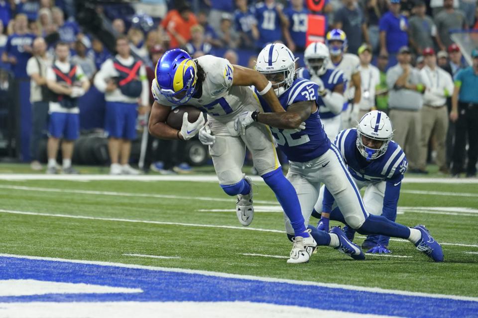 Los Angeles Rams wide receiver Puka Nacua, left, scores a touchdown as Indianapolis Colts safety Julian Blackmon defends during overtime in an NFL football game, Sunday, Oct. 1, 2023, in Indianapolis. | Michael Conroy, Associated Press