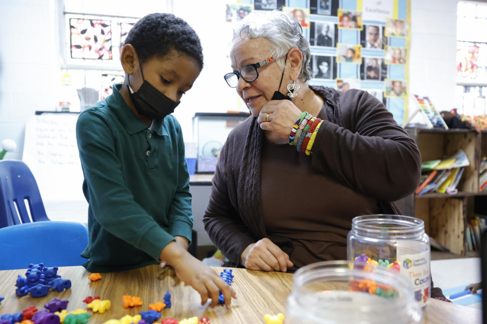 Adewale Ogunlana, 6, of Decatur, Ga., left, works with Aminata Umoja, of Lithonia, Ga., right, in class at the Kilombo Academic and Cultural Institute, Tuesday, March 28, 2023, in Decatur, Ga. (AP Photo/Alex Slitz)