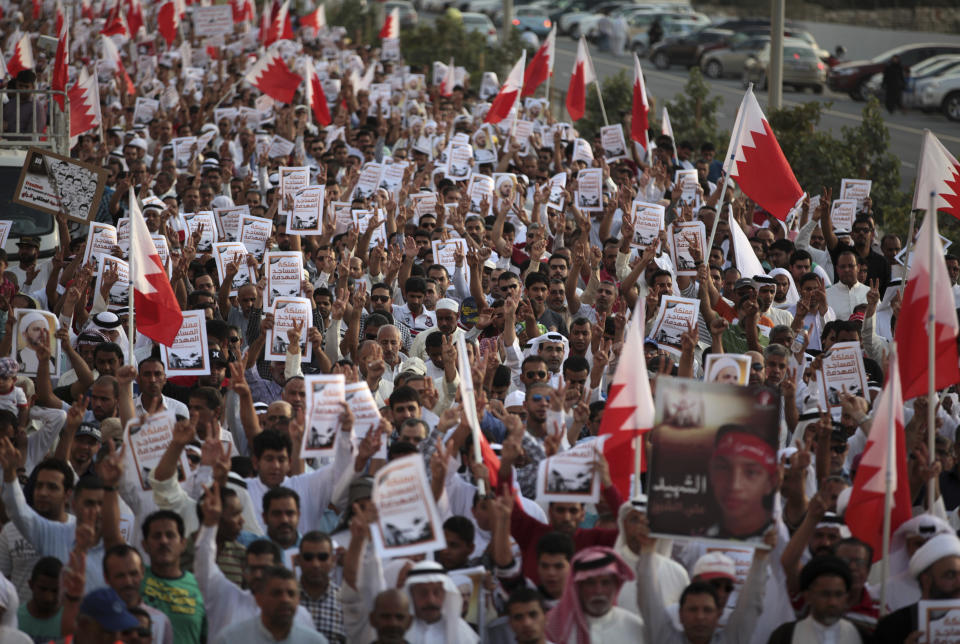 File - In this Friday, April 18, 2014 file photo, thousands of Bahraini anti-government protesters, waving national flags, signs and pictures of jailed political figures and people killed in unrest, chant slogans during a march organized by opposition groups in A'ali, Bahrain. A decade ago, against all odds, a popular uprising convulsed the monarchy of Bahrain as a wave of revolutionary protests swept across the Middle East. But after a brutal crackdown and years of escalating repression, activists say the small kingdom is less free now than even before the Arab Spring, as authorities crush hopes for political reform. (AP Photo/Hasan Jamali, File)