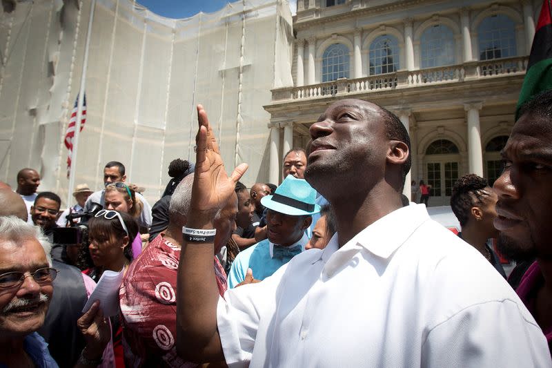 FILE PHOTO: Salaam, one of the wrongly convicted "Central Park Five", gestures while praising god following a news conference announcing the payout for the case at City Hall in New York