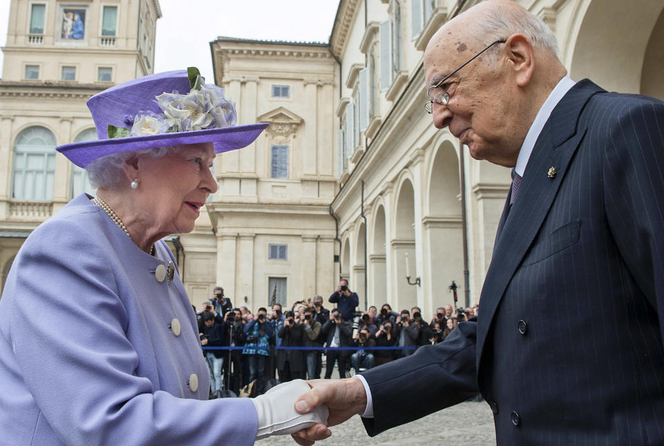 In this picture, publicly distributed by the Italian Presidency Press Office, Italian President Giorgio Napolitano, right, welcomes Queen Elizabeth II upon her arrival at Rome's Quirinale Presidential Palace, Thursday, April 3, 2014, as part of a one-day visit to Italy and the Vatican. The British Royals will meet with Pope Francis in the afternoon. (AP Photo/Italian Presidency Press Office)