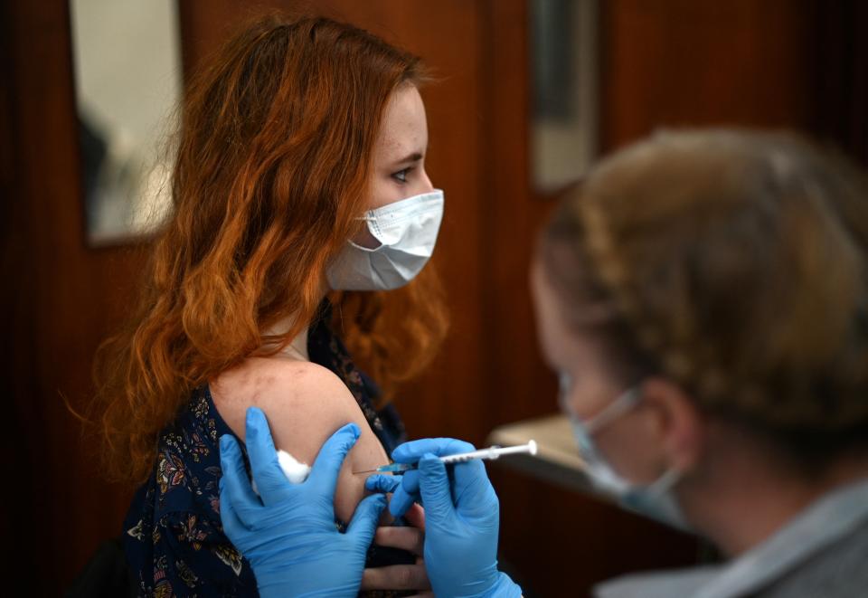 A member of the public receives a second dose of a Pfizer Covid-19 vaccine jab at a temporary coronavirus vaccination centre set up inside St John's Church in west London on December 4, 2021. - Britain, which has been among the hardest hit by Covid-19 with more than 145,000 deaths, is racing to offer third doses of coronavirus vaccines to all adults aged over 18 through its state-run National Health Service. (Photo by Daniel LEAL / AFP) (Photo by DANIEL LEAL/AFP via Getty Images)