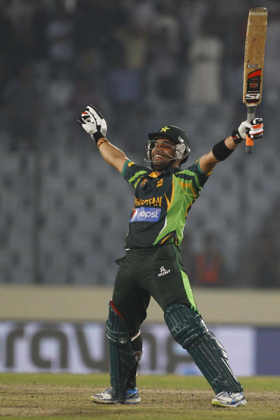 Pakistan’s Umar Akmal celebrates after winning their match against Bangladesh in the Asia Cup one-day international cricket tournament in Dhaka, Bangladesh, Tuesday, March 4, 2014. (AP Photo/A.M. Ahad)