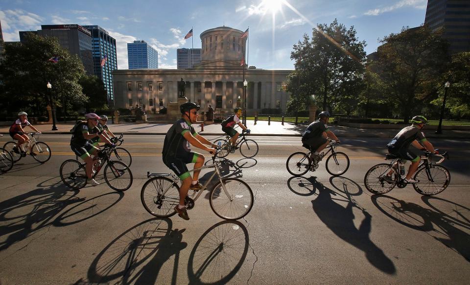 Pelotonia riders pass the Ohio Statehouse while headed south on High St. in 2017