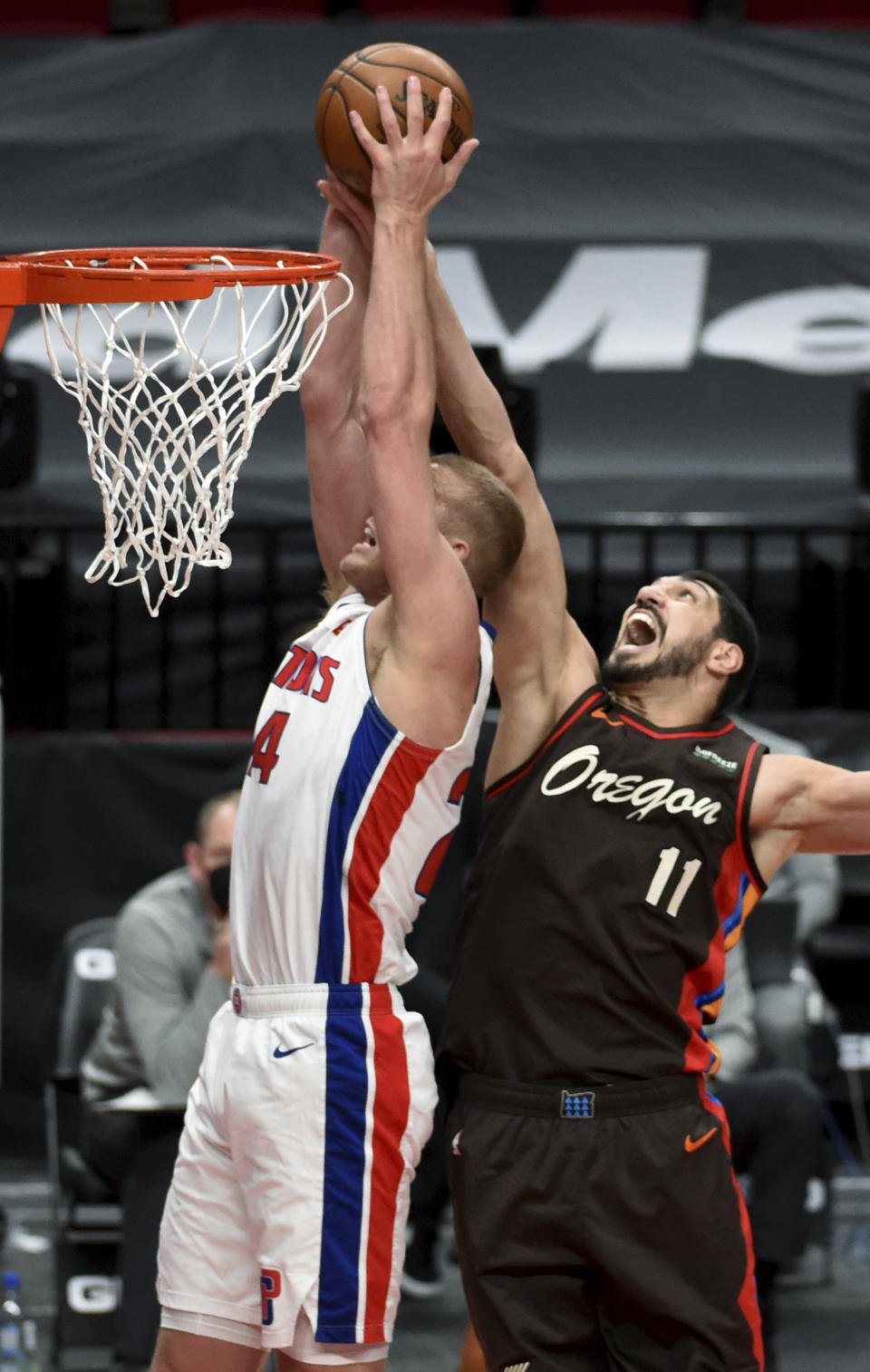 Detroit Pistons center Mason Plumlee, left, and Portland Trail Blazers center Enes Kanter, right go up for a rebound during the first half of an NBA basketball game in Portland, Ore., Saturday, April 10, 2021. (AP Photo/Steve Dykes)