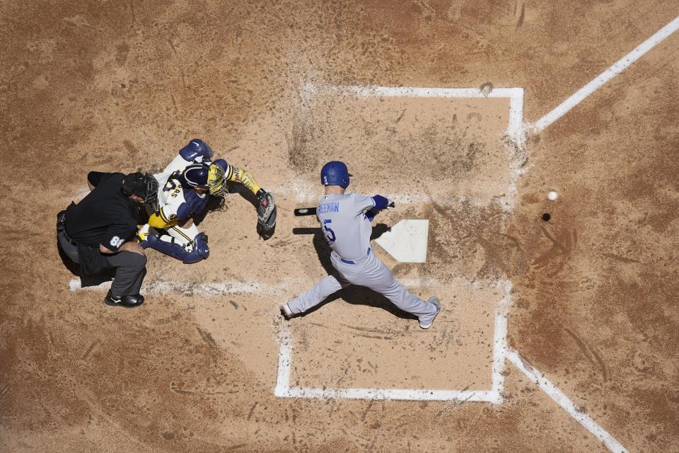 Los Angeles Dodgers' Freddie Freeman hits a two-run scoring single during the fifth inning of a baseball game against the Milwaukee Brewers Wednesday, May 10, 2023, in Milwaukee. (AP Photo/Morry Gash)