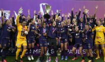 Players of Corinthians celebrate with the trophy after winning the Sao Paulo championship Women's soccer final match against Sao Paulo at Neo Quimica arena in Sao Paulo, Brazil, Wednesday, Dec. 8, 2021. (AP Photo/Andre Penner)