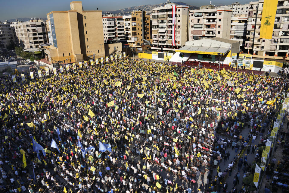 Hezbollah supporters wave their group flags, as they attend an election campaign, in the southern suburb of Beirut, Lebanon, Tuesday, May 10, 2022. Despite a devastating economic collapse and multiple other crises gripping Lebanon, the culmination of decades of corruption and mismanagement, the deeply divisive issue of Hezbollah's weapons has been at the center of Sunday's vote for a new 128-member parliament. (AP Photo/Hussein Malla)