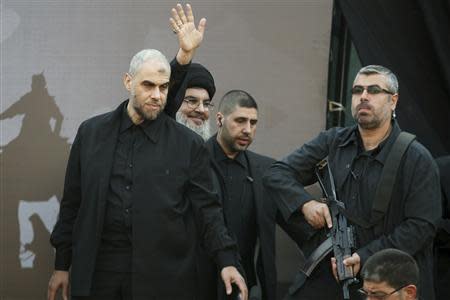 Lebanon's Hezbollah leader Sayyed Hassan Nasrallah greets his supporters during a religious procession to mark Ashura in Beirut's suburbs November 14, 2013. REUTERS/Khalil Hassan