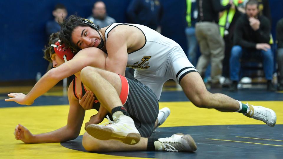 McQuaid's Harrison Aguirre, right, wrestles South Lewis' Matthew Mark in the final of the 215-pound weight class during the Teike-Bernabi Wrestling Tournament, Friday, Dec. 29, 2023.