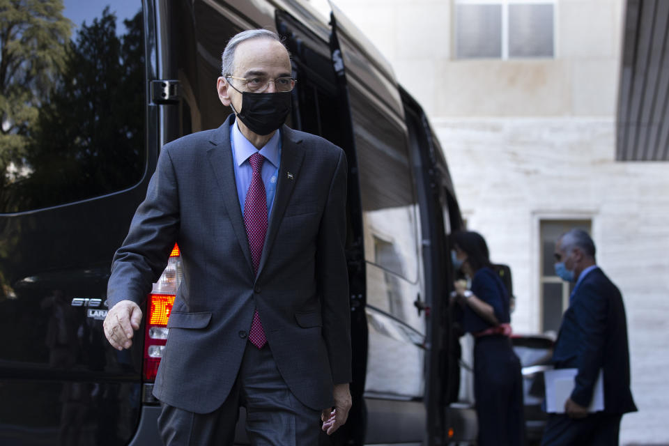 The Syrian Constitutional Committee Co-Chair Hadi al-Bahra, left, wearing face mask as precaution against the spread of the coronavirus as he leaves the building following the announcement of the suspension of the conference due to cases of Covid-19, affecting members of one of the delegations, at the European headquarters of the United Nations in Geneva, Switzerland, Monday, Aug. 24, 2020. (Salvatore Di Nolfi/Keystone via AP)