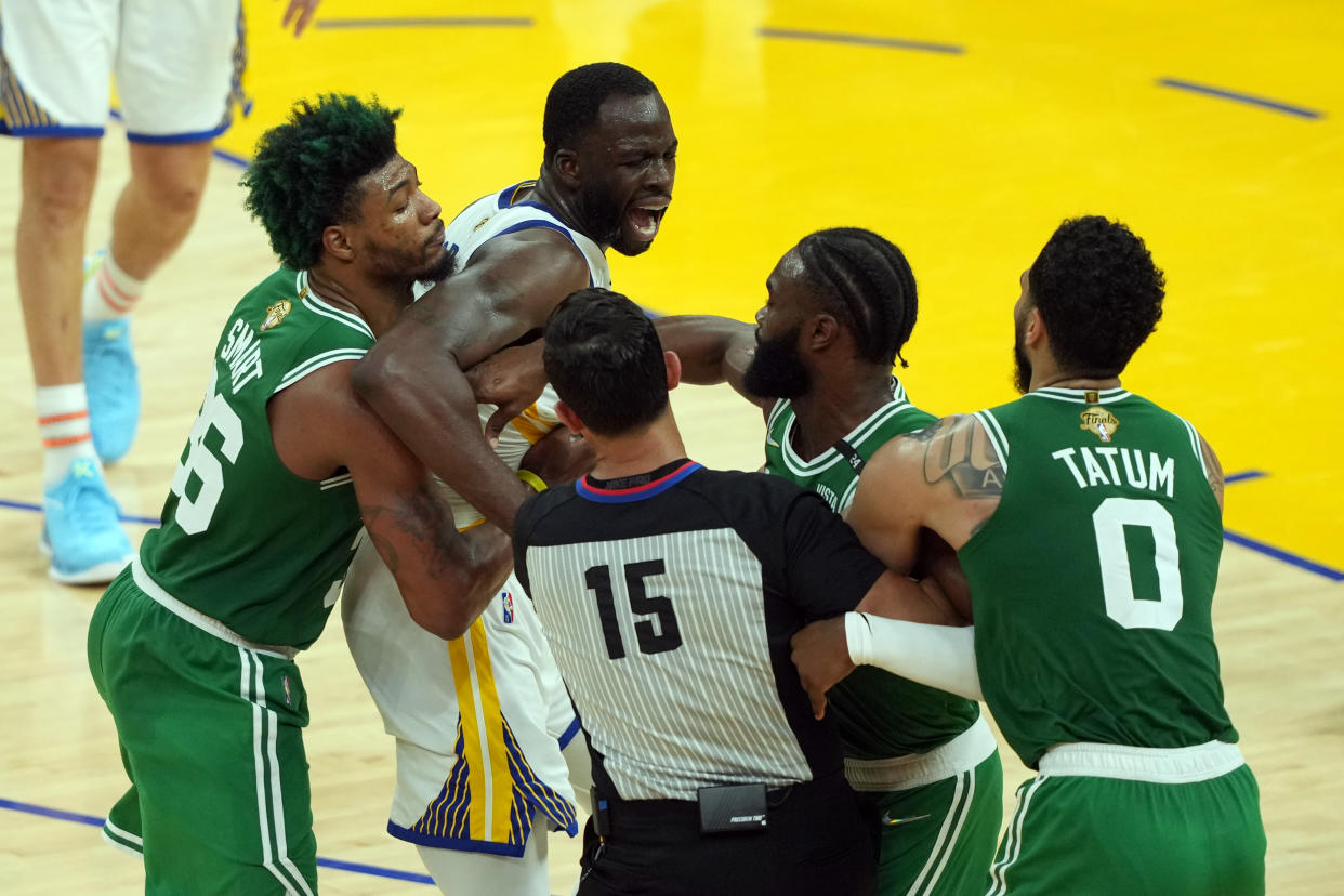 Jun 5, 2022; San Francisco, California, USA; Golden State Warriors forward Draymond Green (23) and Boston Celtics guard Jaylen Brown (7) react after a play as Boston Celtics guard Marcus Smart (36) and Boston Celtics forward Jayson Tatum (0) assist in the second half during game two of the 2022 NBA Finals at Chase Center. Mandatory Credit: Darren Yamashita-USA TODAY Sports