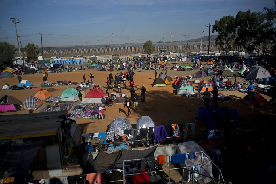 Immigrants settle at a shelter in Tijuana, Mexico, Wednesday, Nov. 21, 2018. Migrants camped in Tijuana after traveling in a caravan to reach the U.S are weighing their options after a U.S. court blocked President Donald Trump's asylum ban for illegal border crossers. (AP Photo/Ramon Espinosa)