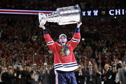 Chicago captain Jonathan Toews hoists the Cup in front of the home fans at the United Center. (AP)