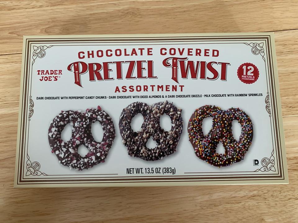 trader joes chocolate-covered pretzels in white box on wood table